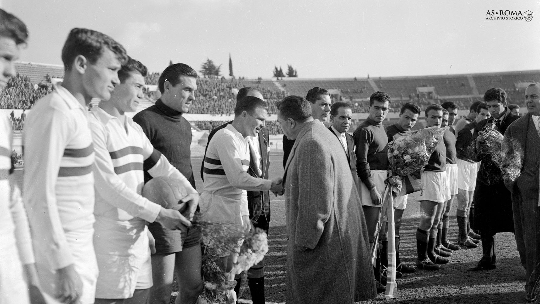 Il presidente della FIGC Ottorino Barassi stringe la mano a Ferenc Puskas in occasione di Roma-Honved 3-2, amichevole della stagione 1956/1957, Roma, Stadio Olimpico, mercoledì 12 dicembre 1956. Osservano la scena, a destra, il capitano romanista Arcadio Venturi e i giallorossi Luigi Giuliano e Giacomo Losi.